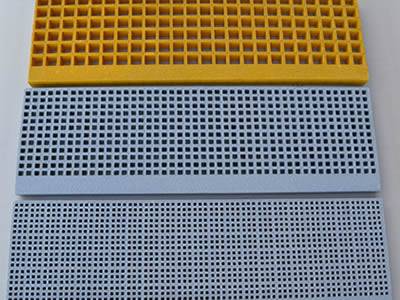 The picture shows three pieces of FRP mini mesh stair treads in yellow and gray.
