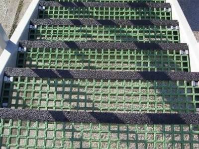 This picture shows one part of fiberglass stairs, which has green grids and black gritted nosing.