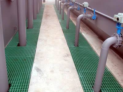 It shows that several green molded GRP grating are installed around the tubes for large facility.