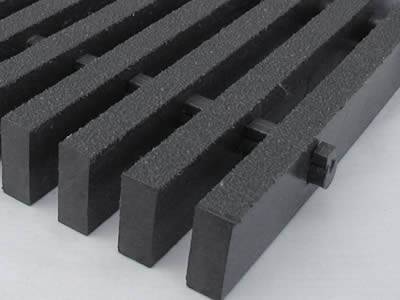 One piece of pultruded high load capacity fiberglass grating in dark gray.
